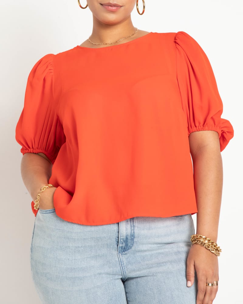 Front of a model wearing a size 14 Cassadee Open Tie Back Top in Red Alert by ELOQUII. | dia_product_style_image_id:216365
